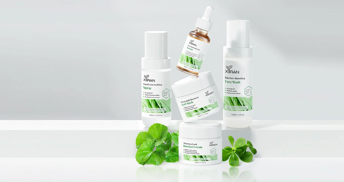 Assortment of Xiran skincare products including face wash, gel mask, and soothing spray arranged with leaves on a reflective surface.